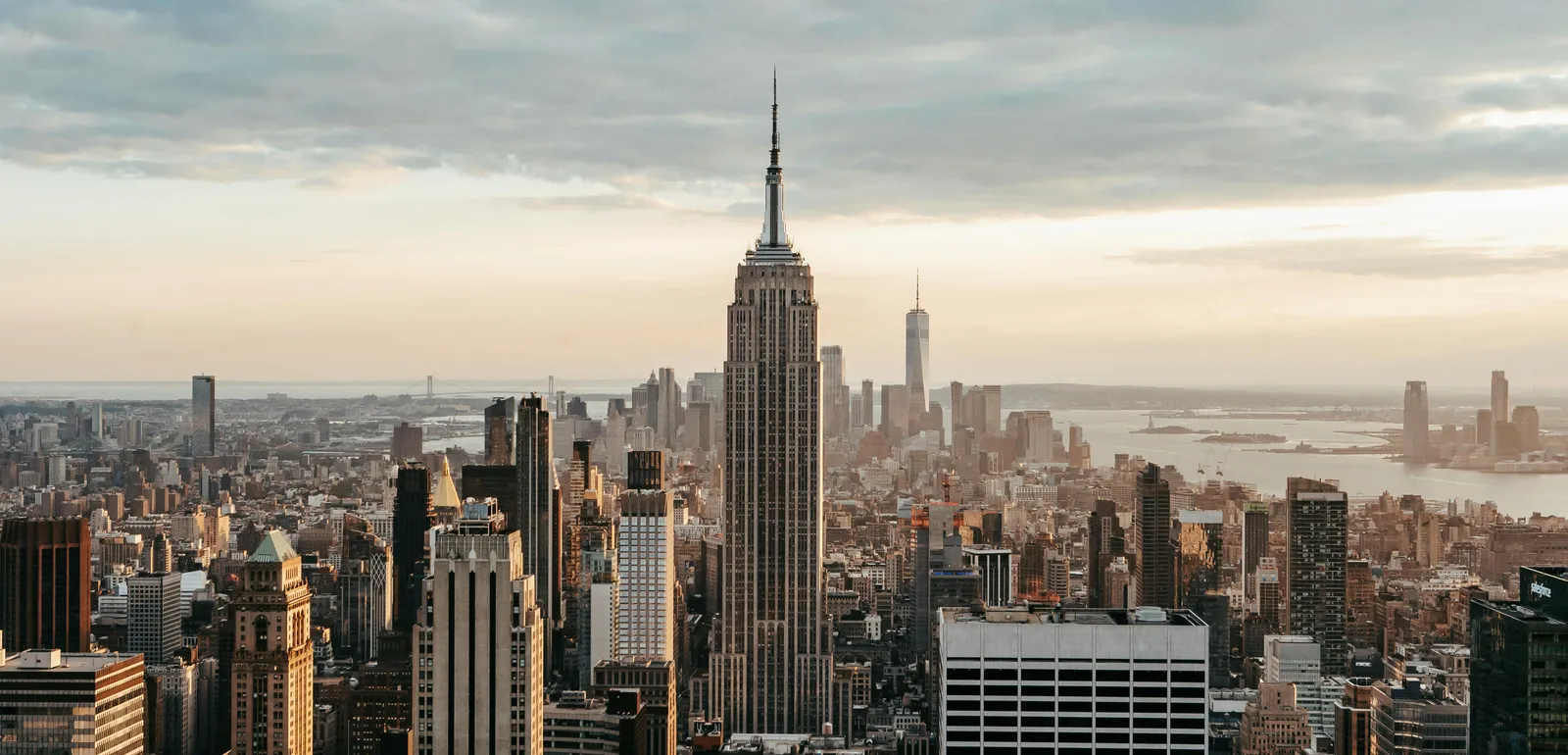 Modern multistage house exteriors against endless sea under cloudy sky in New York City at sunset
